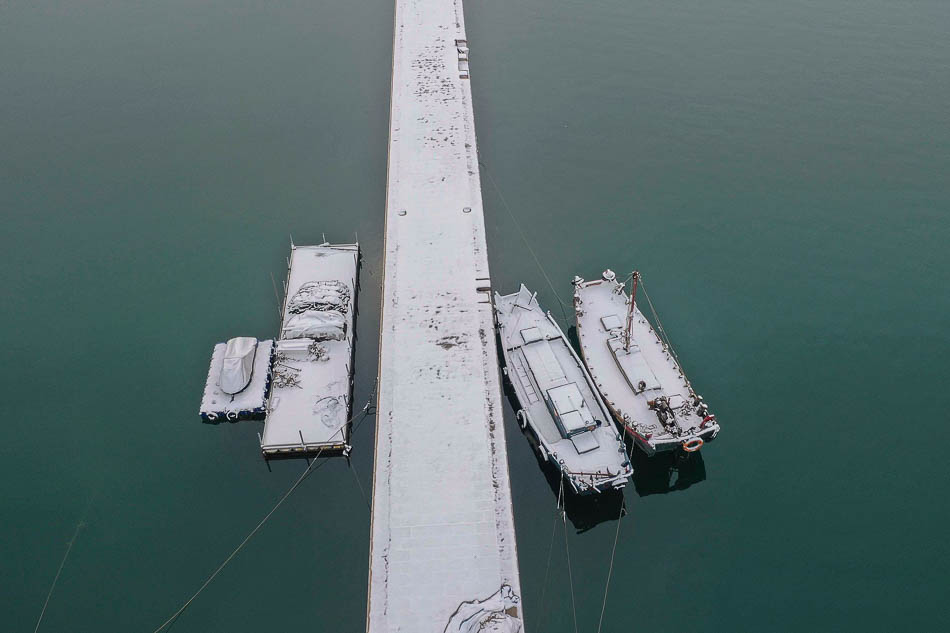 06-VCG111191583159山東青島：雪沃漁港 圣潔如畫圖片說明2019年2月14日凌晨，一場春雪飄灑在青島西海岸新區(qū)，唐島灣漁港銀裝素裹，如童話一般美麗。一艘艘漁船兒被白雪覆蓋，圣潔如畫。