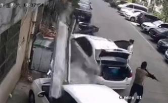 公寓楼顶水泥块脱落，2车被砸路人奔逃