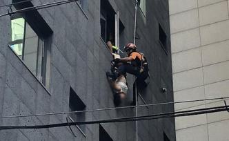 中国女游客在韩国跳楼被路人抓住双脚，倒挂40分钟后获救