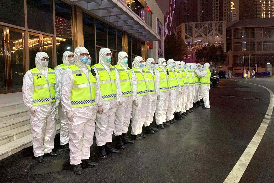 洪山體育館外，執(zhí)勤人員全服武裝等待第一批患者到達(dá)。